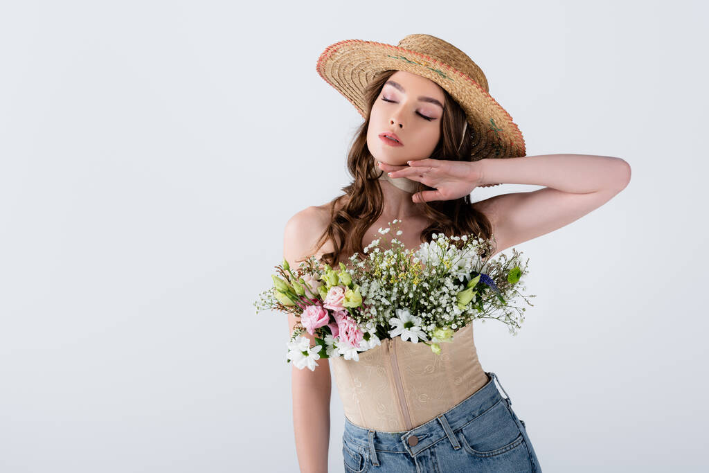 Woman in straw hat and blouse with flowers isolated on grey  - Photo, Image