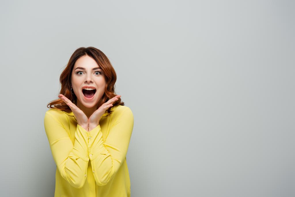 excited young woman with open mouth gesturing isolated on grey - Photo, Image