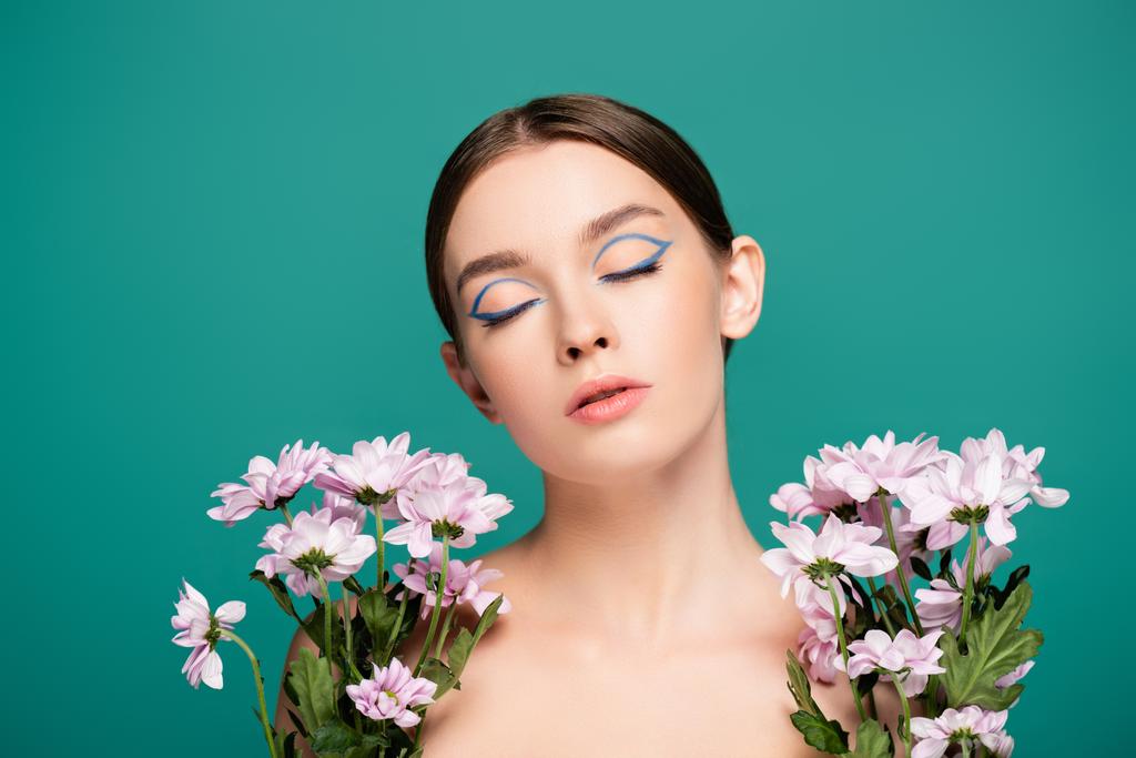 sensual woman with closed eyes near pink chrysanthemums isolated on green - Photo, Image