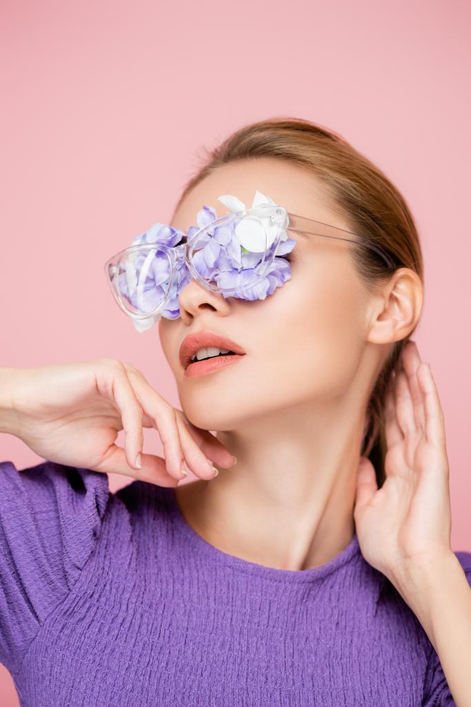 sensual woman with flowers in eyeglasses posing isolated on pink - Photo, Image