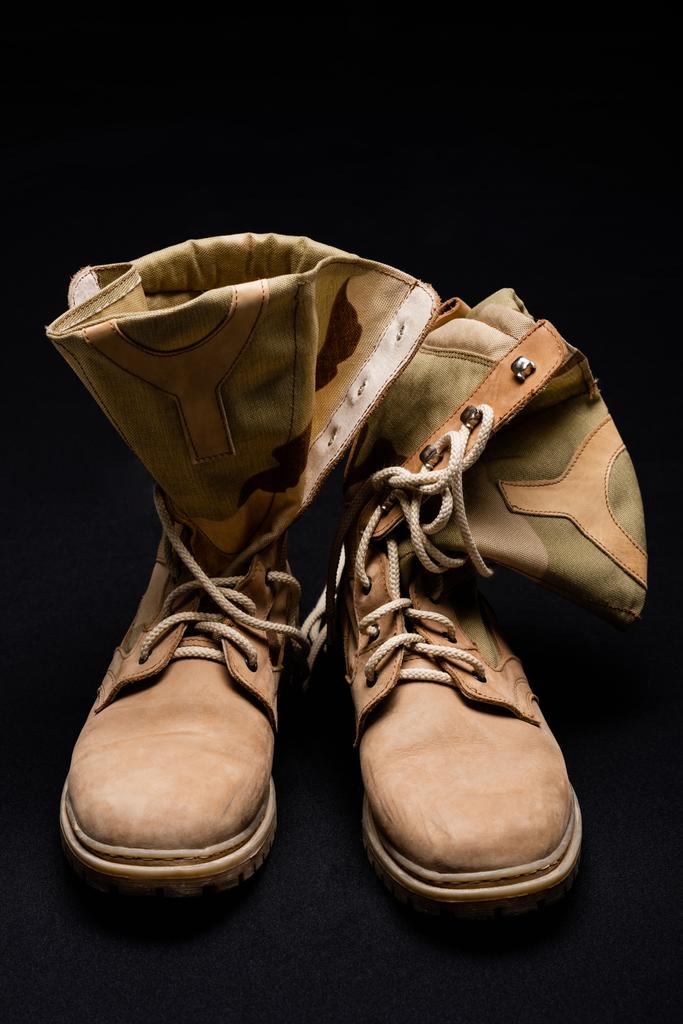 Close up view of military boots on black background  - Photo, Image