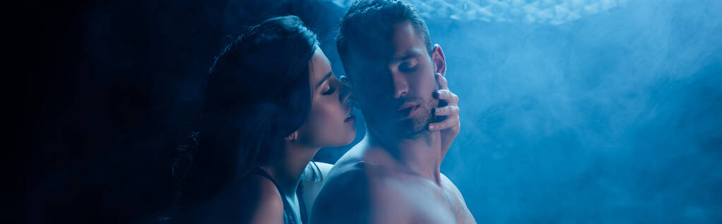 Sexy woman touching shirtless boyfriend on black background with smoke, banner  - Photo, Image