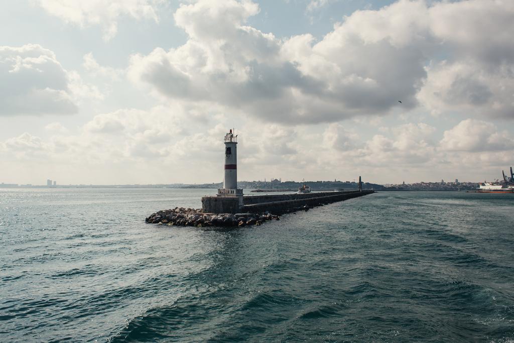 Pier and lighthouse in sea with cloudy sky at background, Istanbul, Turkey  - Photo, Image