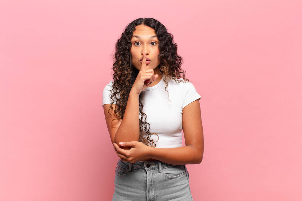 young hispanic woman looking serious and cross with finger pressed to lips demanding silence or quiet, keeping a secret - Photo, Image