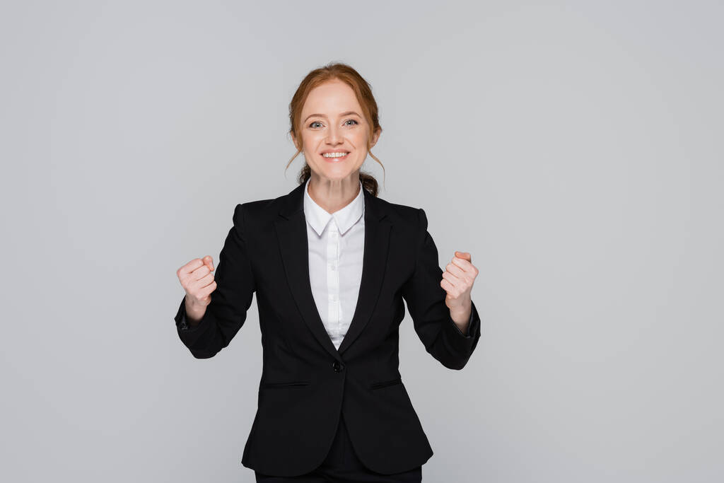 Red haired businesswoman showing yes gesture isolated on grey  - Photo, Image