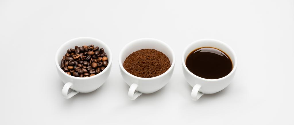 cups with prepared and ground coffee near beans on white, banner - Photo, Image