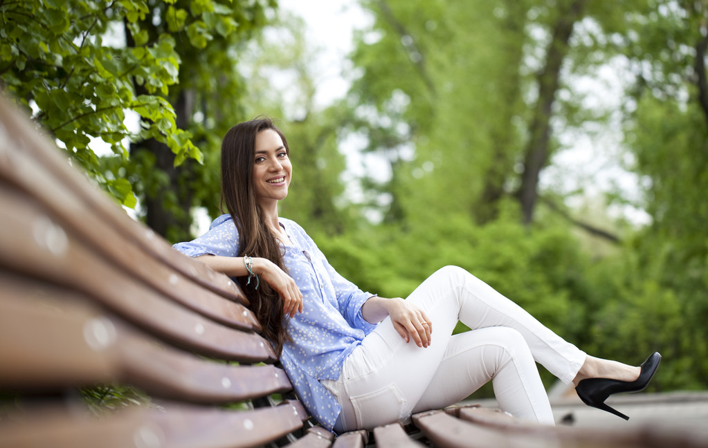 Brunette sitting on a bench  - Photo, Image