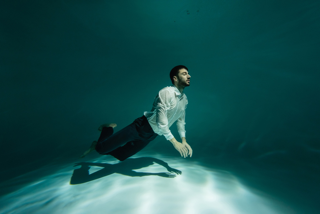 Muszlim férfi úszás víz alatt medencében  - Fotó, kép