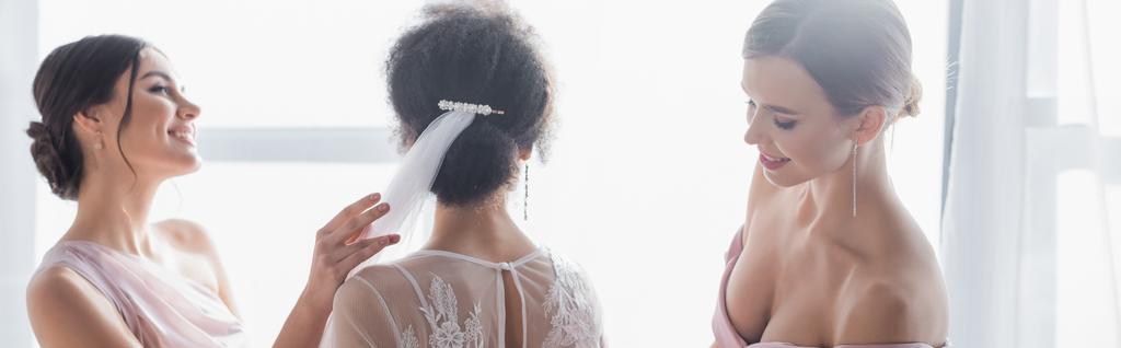 back view of african american woman near smiling friends preparing her for wedding, banner - Photo, Image