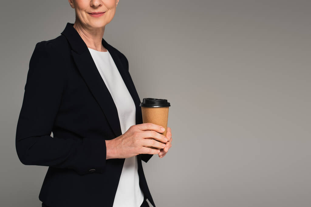Cropped view of manager holding coffee to go isolated on grey  - Photo, Image