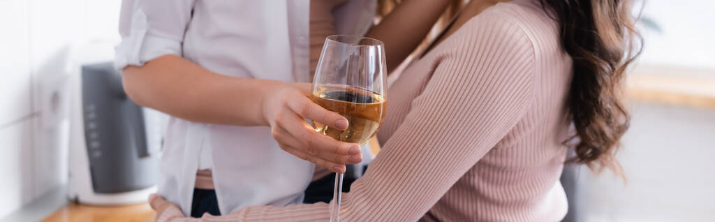 cropped view of woman holding glass of wine near girlfriend, banner - Photo, Image