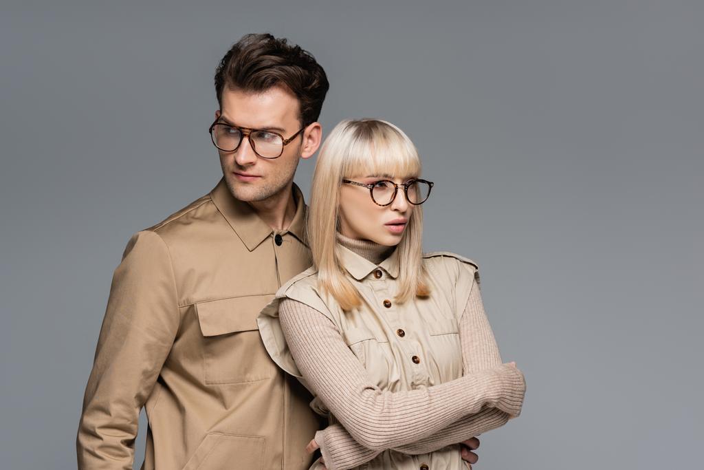 trendy young models in glasses posing isolated on grey - Photo, Image