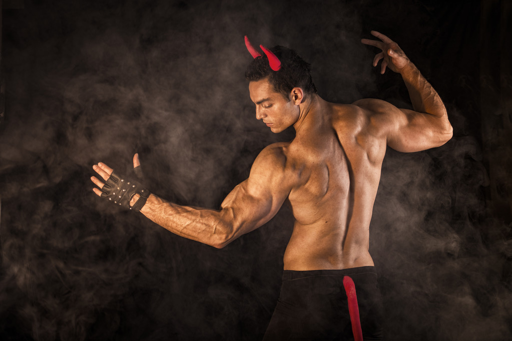 悪魔コスチュームに身を包んだ上半身裸の筋肉男性のボディービルダー - 写真・画像