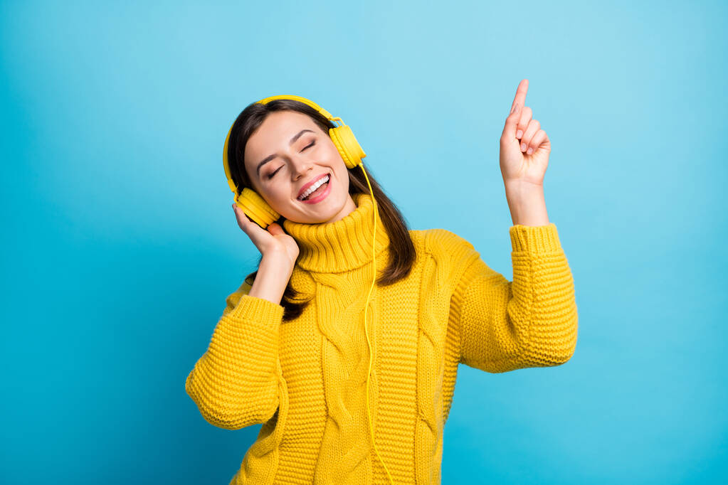 Portrait of charming cheerful dreamy girl listening soul single modern hip hop isolated over vivid blue color background - Photo, Image