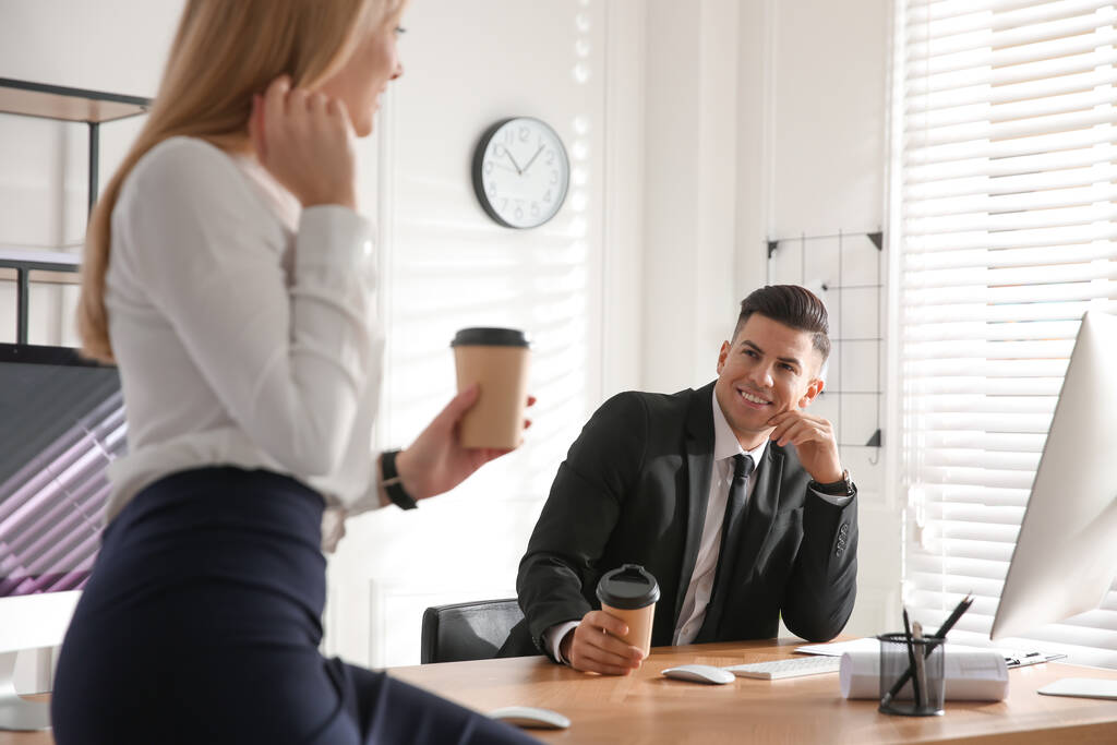 Man flirting with his colleague during coffee break in office - Photo, Image