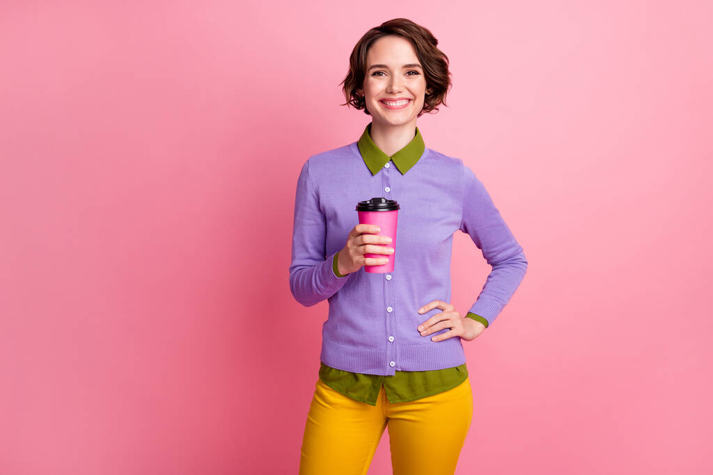 Photo of positive cheerful girl enjoy rest relax hold cappuccino cup wear pants isolated over pastel color background - Photo, Image