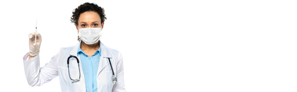 Африканський американський лікар у медичній масці та рукавичці латексу, що тримає шприц ізольований на білому банері  - Фото, зображення
