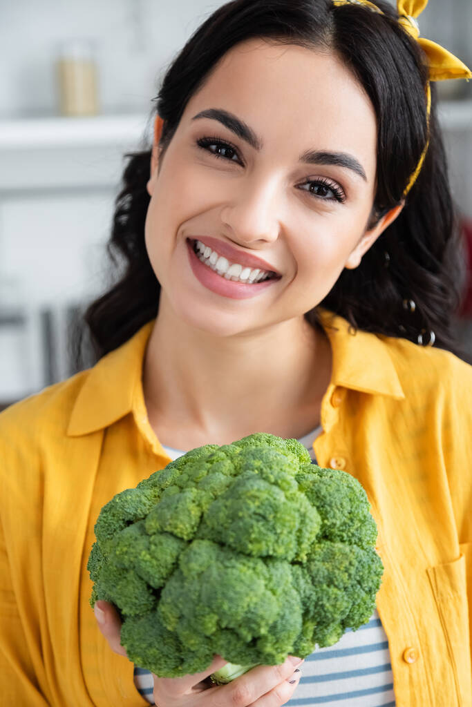 feliz morena mujer sosteniendo maduro verde brócoli  - Foto, imagen