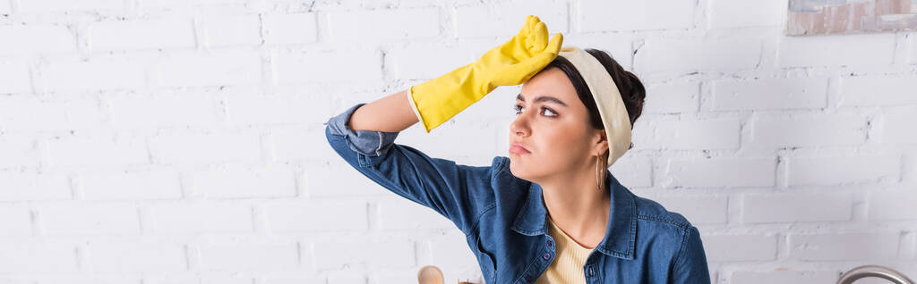 Tired housewife in rubber glove at home, banner  - Photo, Image