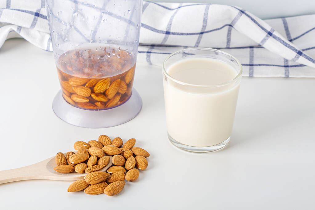 Step by step recipe. Cooking nuts vegetable milk. Step 3 cooked  almonds milk in glass. Homemade food concept. Plant based organic veggie milk, lactose free.  - Photo, Image