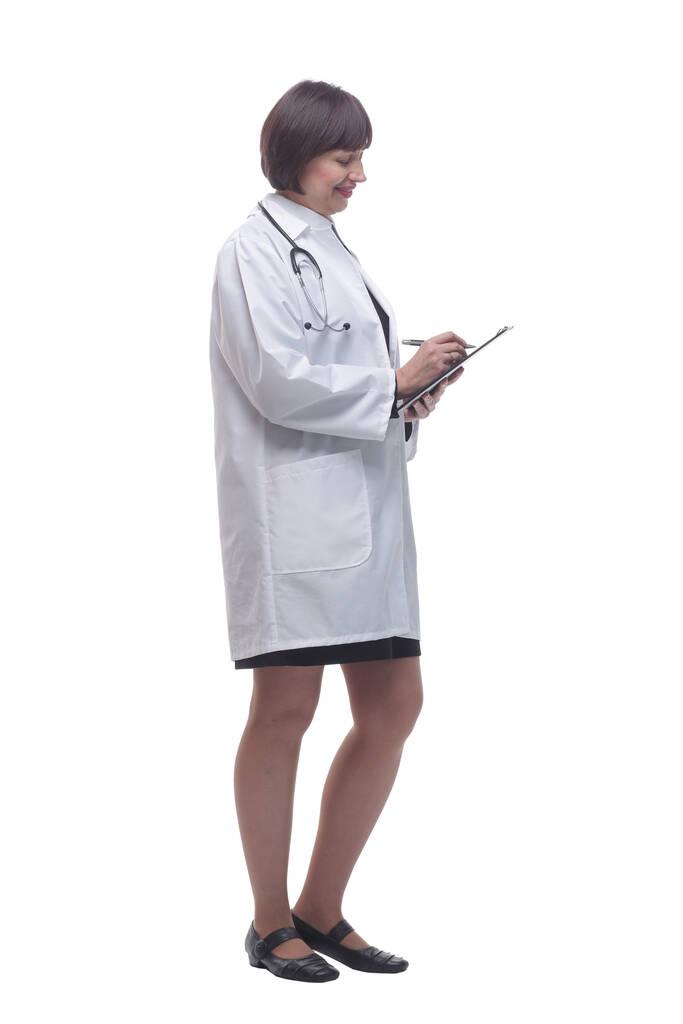 female medic making notes to the clipboard . isolated on a white background. - Photo, Image