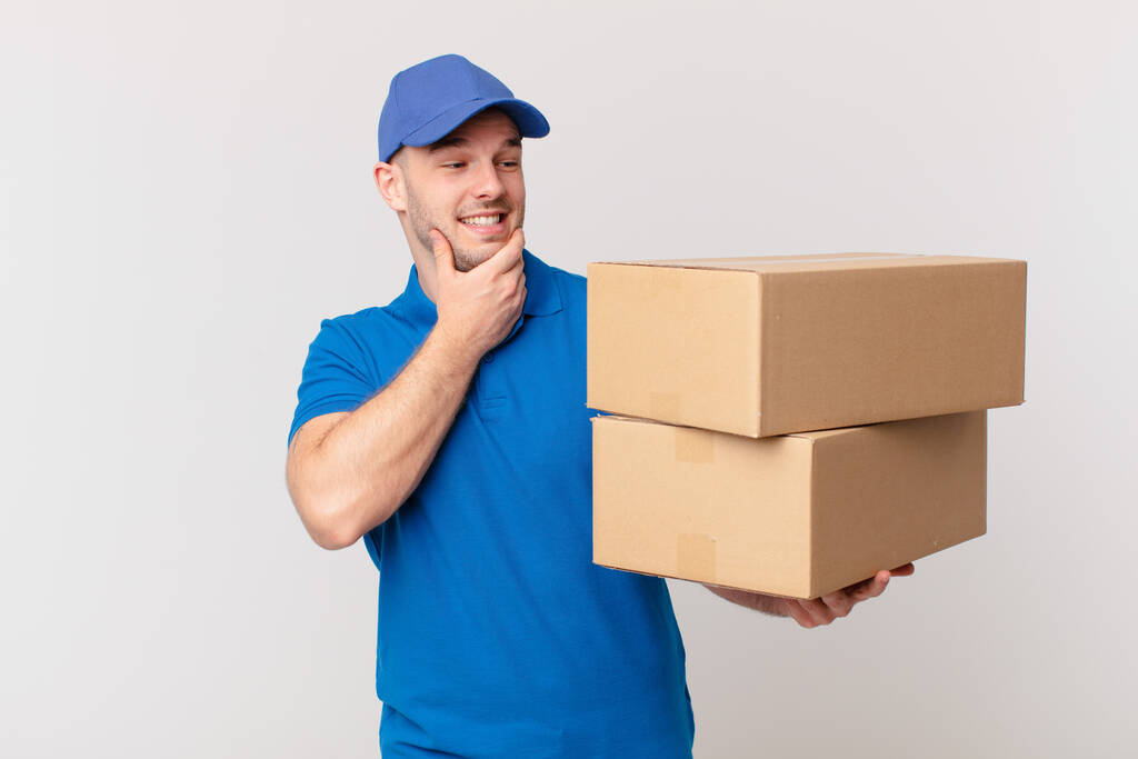 package deliver man smiling with a happy, confident expression with hand on chin, wondering and looking to the side - Photo, Image