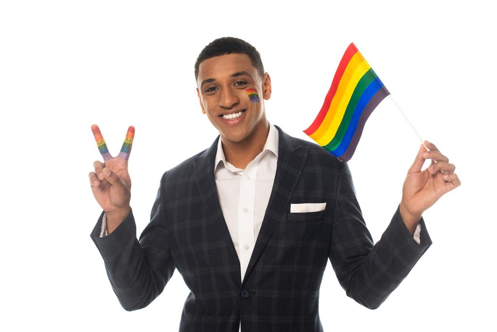 cheerful african american businessman showing victory gesture while holding lgbt flag isolated on white - Photo, Image