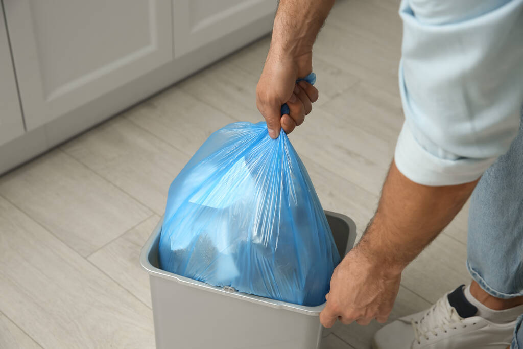 Man taking garbage bag out of bin at home, closeup - Photo, Image