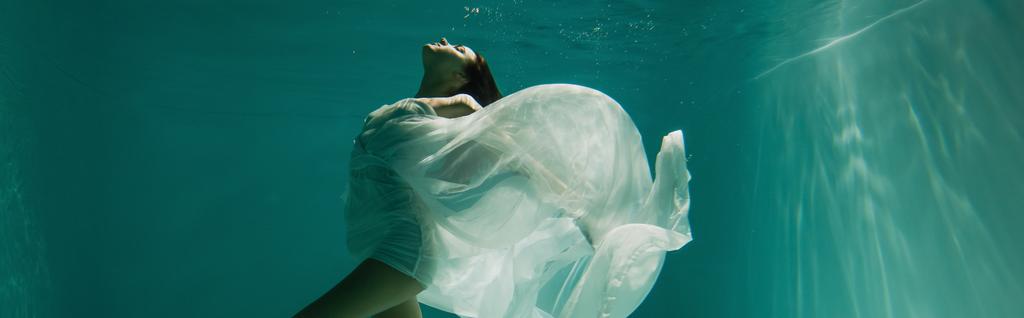 peaceful young woman in white elegant dress swimming in pool, banner - Photo, Image
