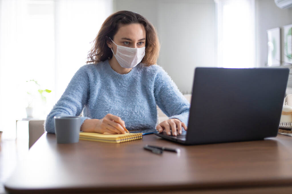Mladá obchodní žena pracující z domova nosit ochrannou masku po coronavirus pandemi - Fotografie, Obrázek