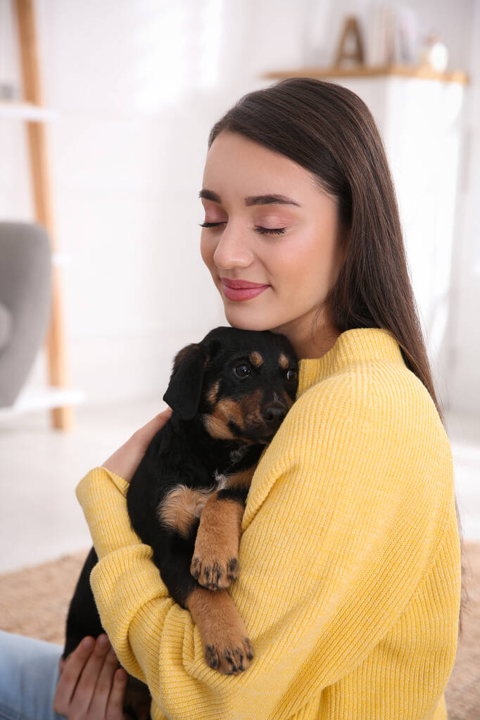 Woman with cute puppy indoors. Lovely pet - Photo, Image