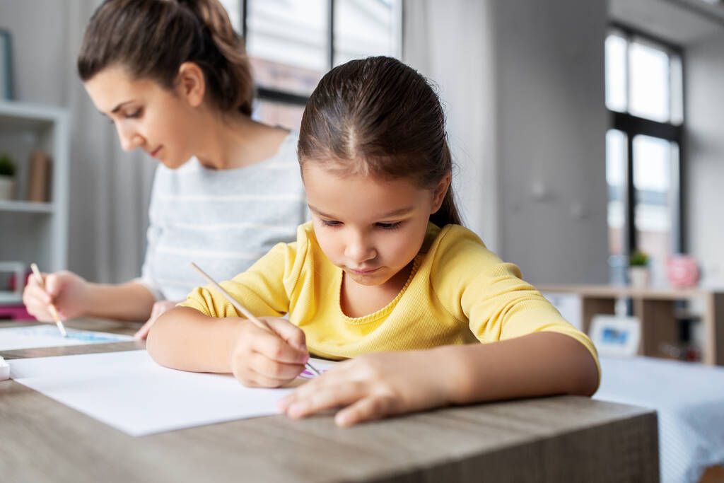 mother with little daughter drawing at home - Photo, Image