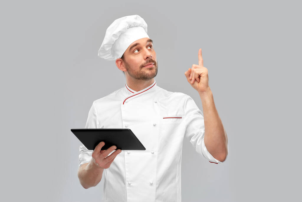 αρσενικό σεφ με tablet υπολογιστή δείχνοντας δάχτυλο προς τα πάνω - Φωτογραφία, εικόνα