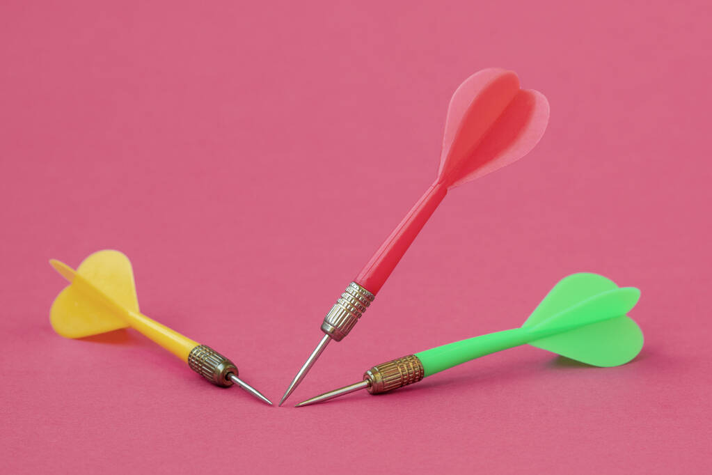 Três setas de dardo coloridas no fundo rosa - Foto, Imagem