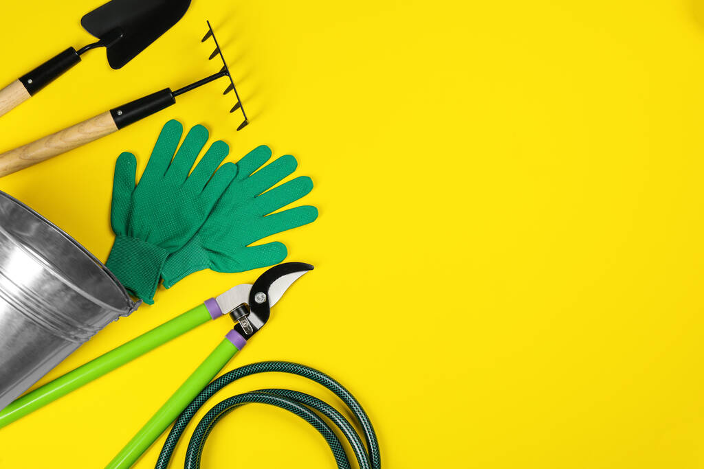 Flat lay composition with gardening tools on yellow background, space for text - Photo, Image