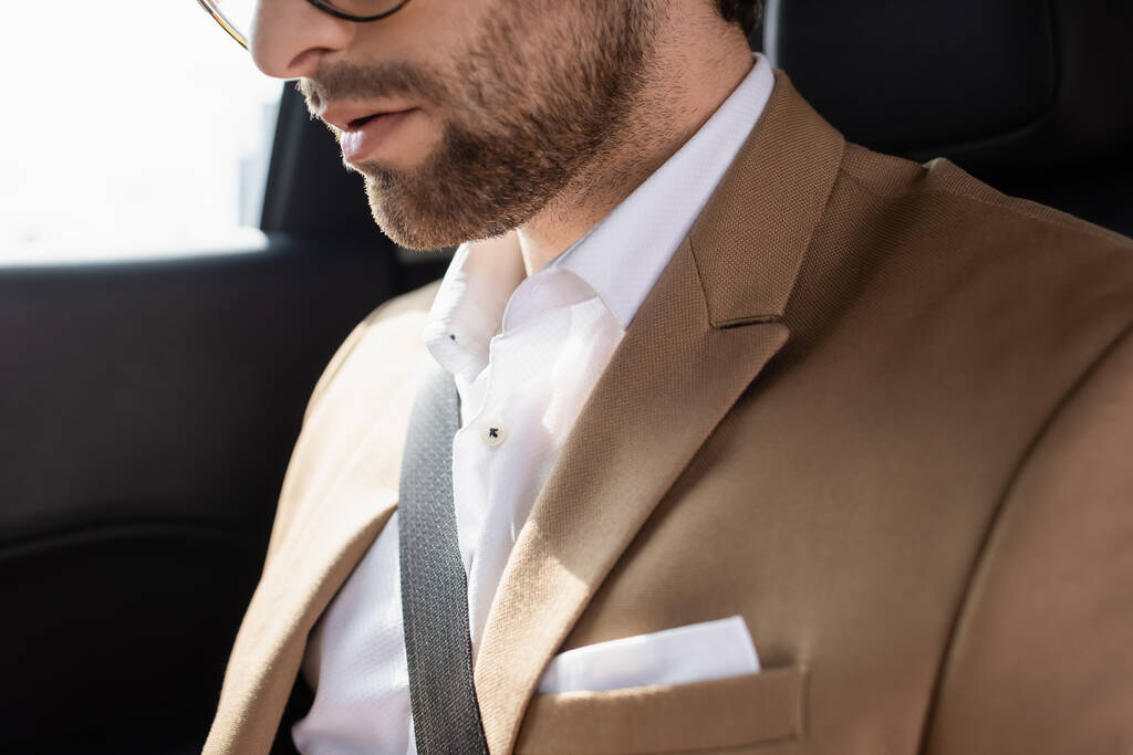 cropped view of bearded man sitting in car - Zdjęcie, obraz