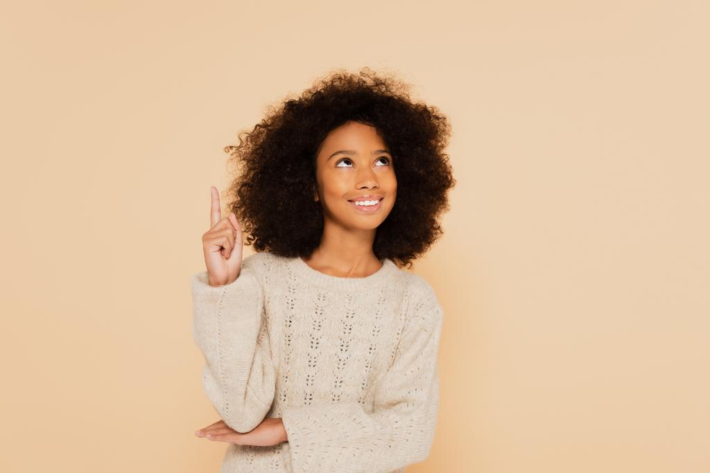 african american preteen girl pointing up with finger isolated on beige - Photo, Image