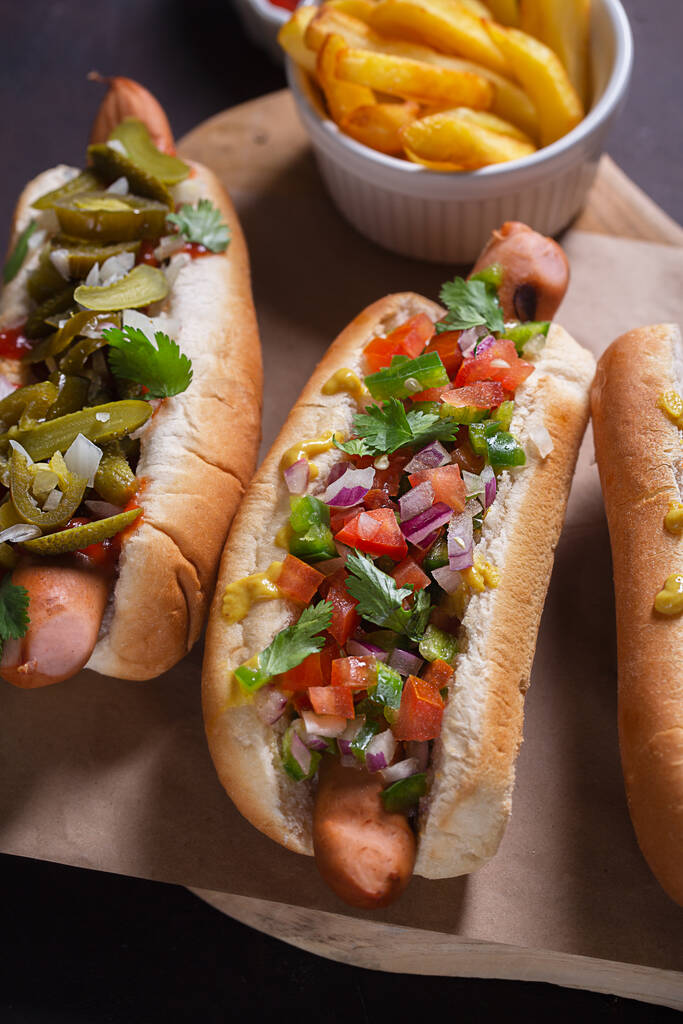Hot dogs avec différentes garnitures épicées, gros plan, mise au point sélective - Photo, image