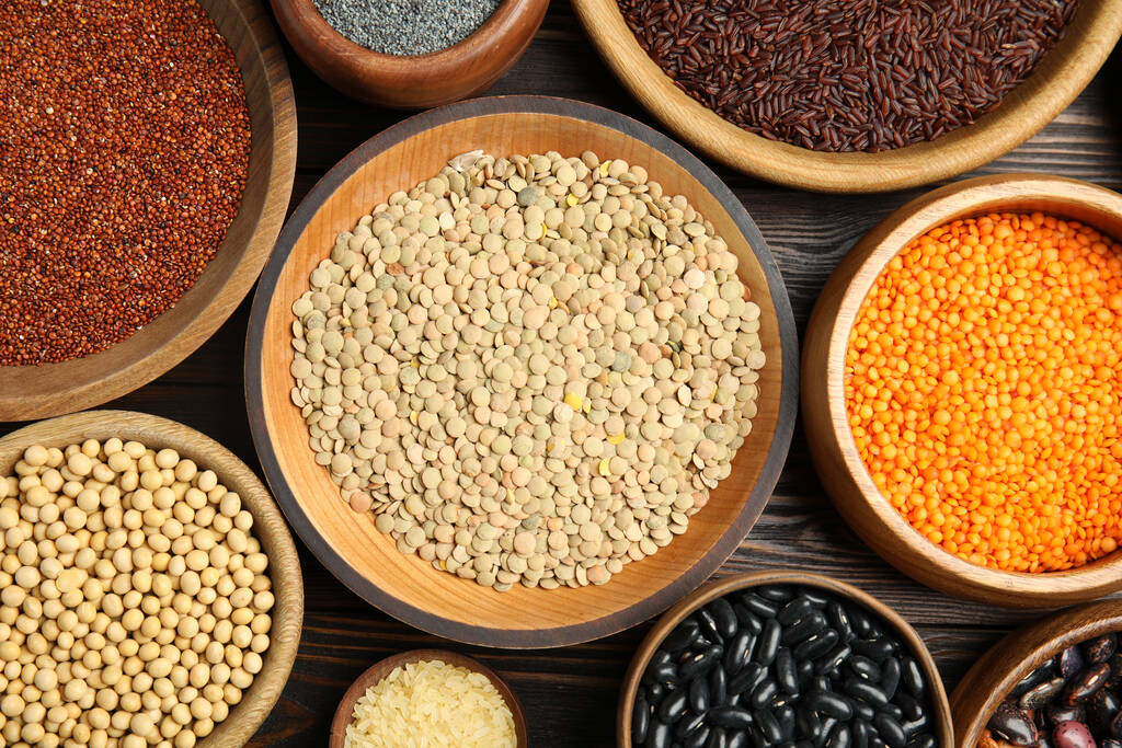 Different grains and seeds on wooden table, flat lay. Veggie diet - Photo, Image
