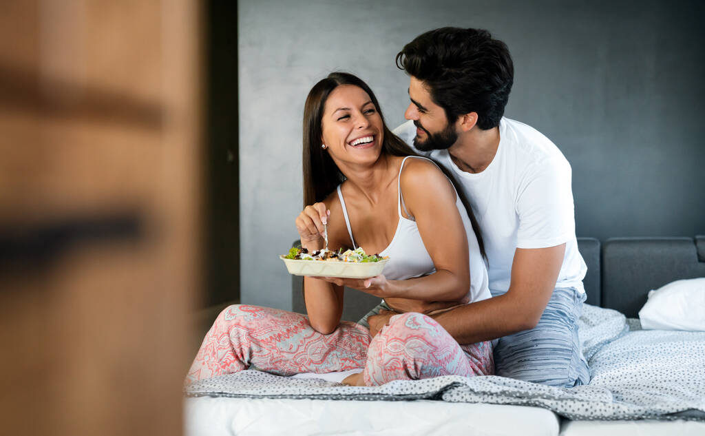 Романтическая счастливая пара завтракает в постели дома - Фото, изображение