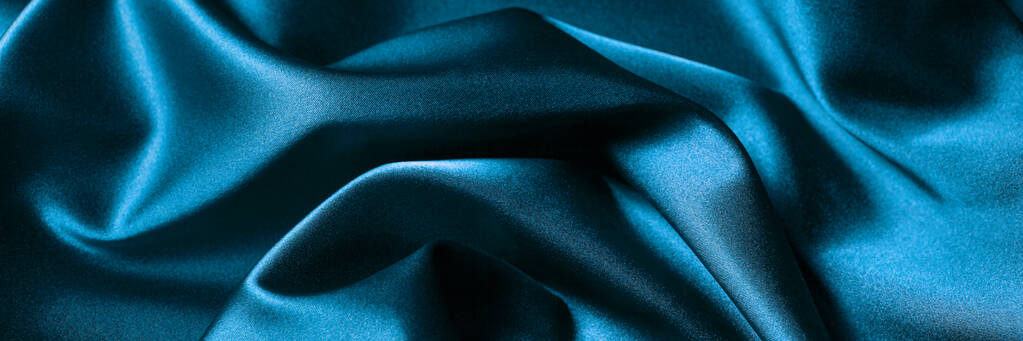 Abstrato pano de fundo de luxo ou onda líquida ou dobras onduladas de material de cetim textura de seda. Fundo azul para design de banner. - Foto, Imagem