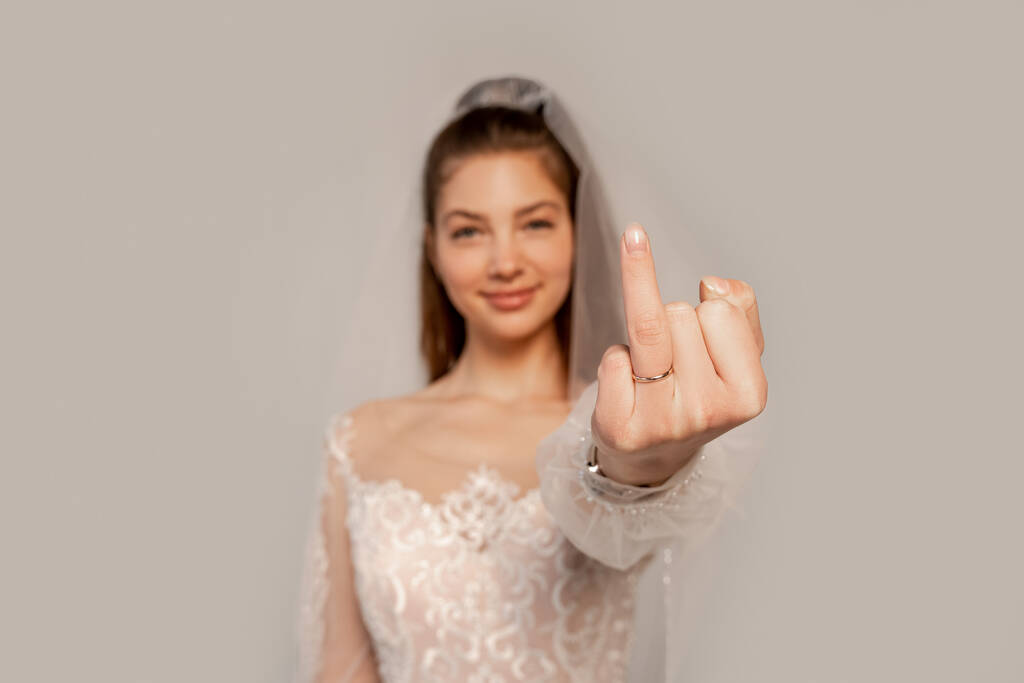 blurred bride showing finger with wedding ring isolated on grey  - Valokuva, kuva