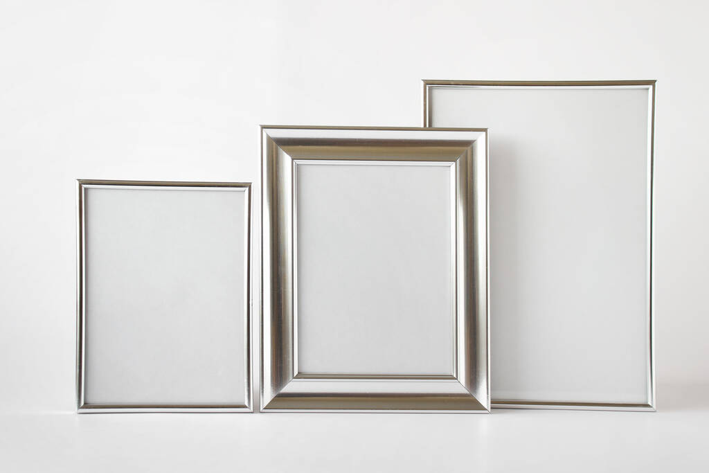 Шаблон макета с набором из трех серебряных глянцевых металлических рам с чистым пространством на белом фоне. - Фото, изображение