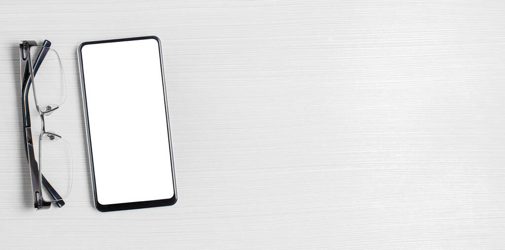 Un smartphone con una pantalla en blanco sobre un fondo blanco. Concepto de aplicación en línea para empresas o inversiones. Copiar espacio - Foto, imagen