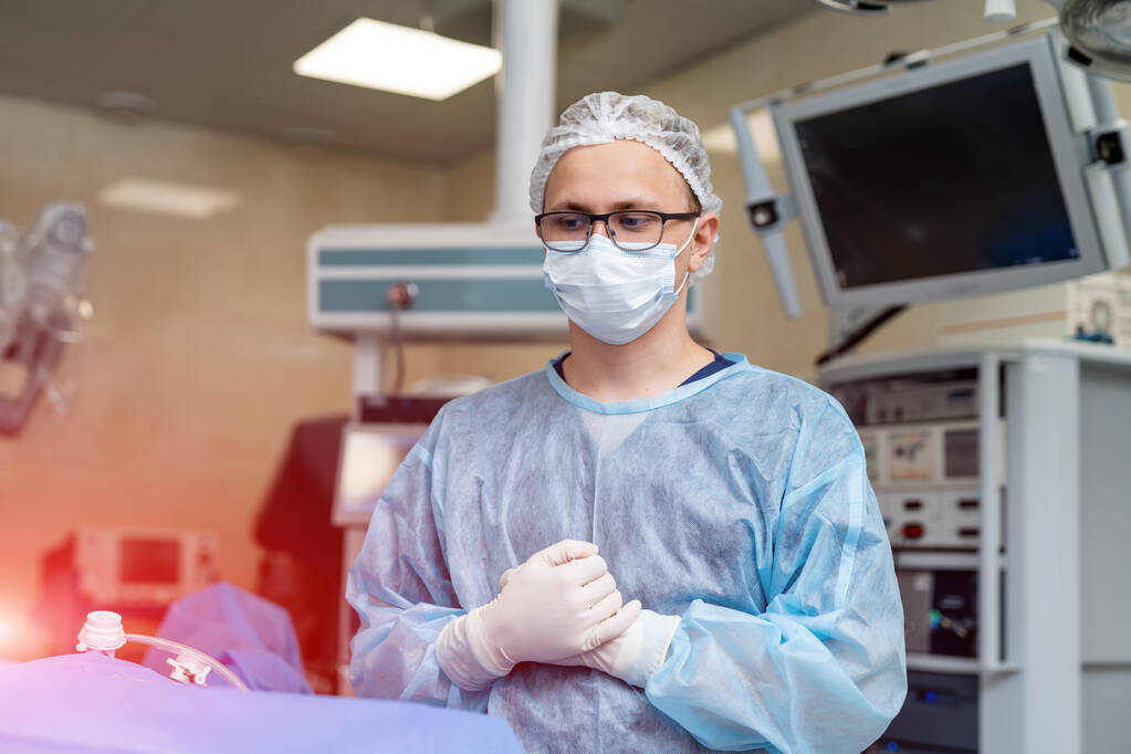 Portrait of doctor during surgery. Doctor concentrating on patient during surgery - Photo, Image