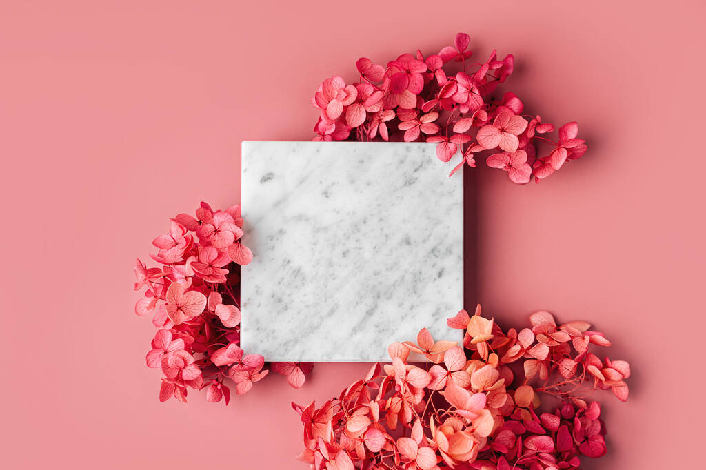 Square marble plate on pink background with flowers. Stylish background for presentation. - Photo, Image