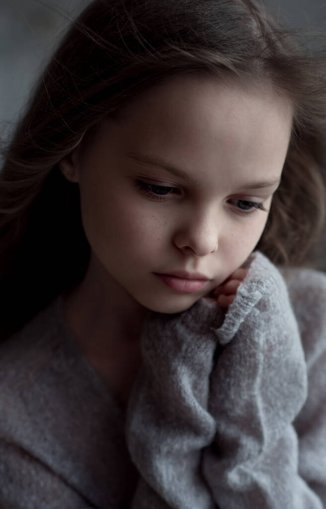 Portrait of a beautiful little girl with meditative, pensive facial expression.  Kid and emotions. - Photo, Image