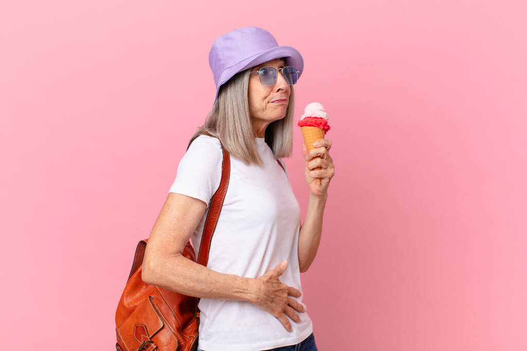 Frau mittleren Alters mit weißem Haar und einem Eis. Sommerkonzept - Foto, Bild