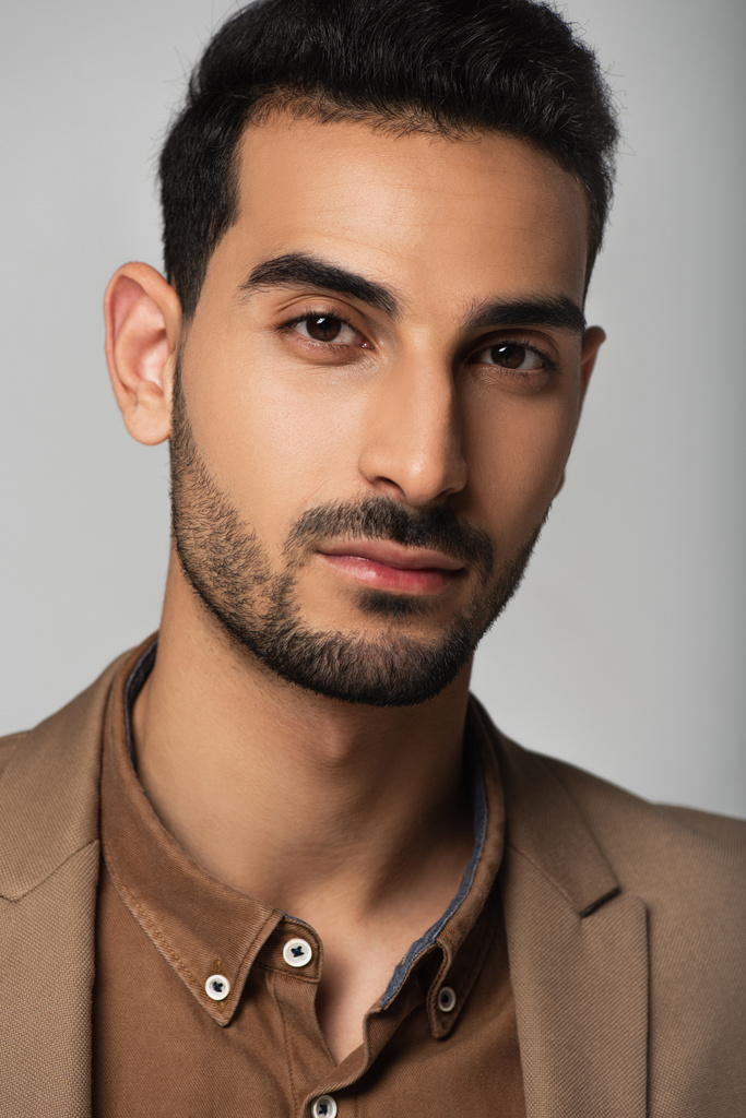 Good looking arabian man in formal wear isolated on grey  - Photo, Image