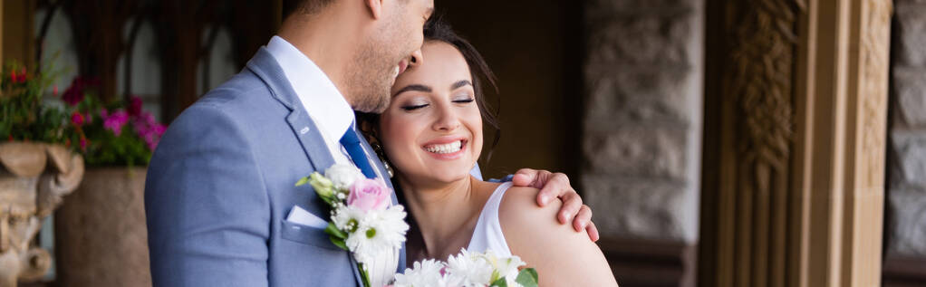 Cheerful groom hugging bride with closed eyes outdoors, banner  - Photo, Image
